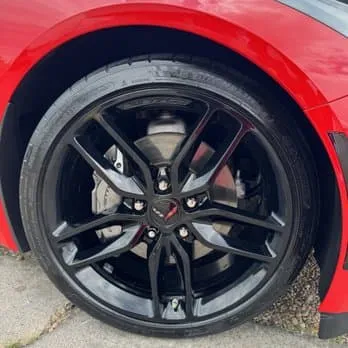Detailed black wheel and brake caliper